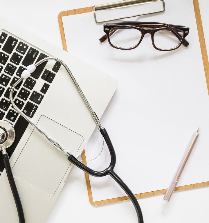 stethoscope-laptop-clipboard-with-eyeglasses-pen-white-background (1)